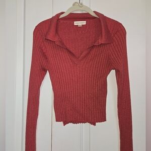 Cropped soft burnt orange long sleeve top with collar and small slits to side